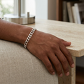 Full length of the wide curb chain bracelet showing its polished silver-tone finish
