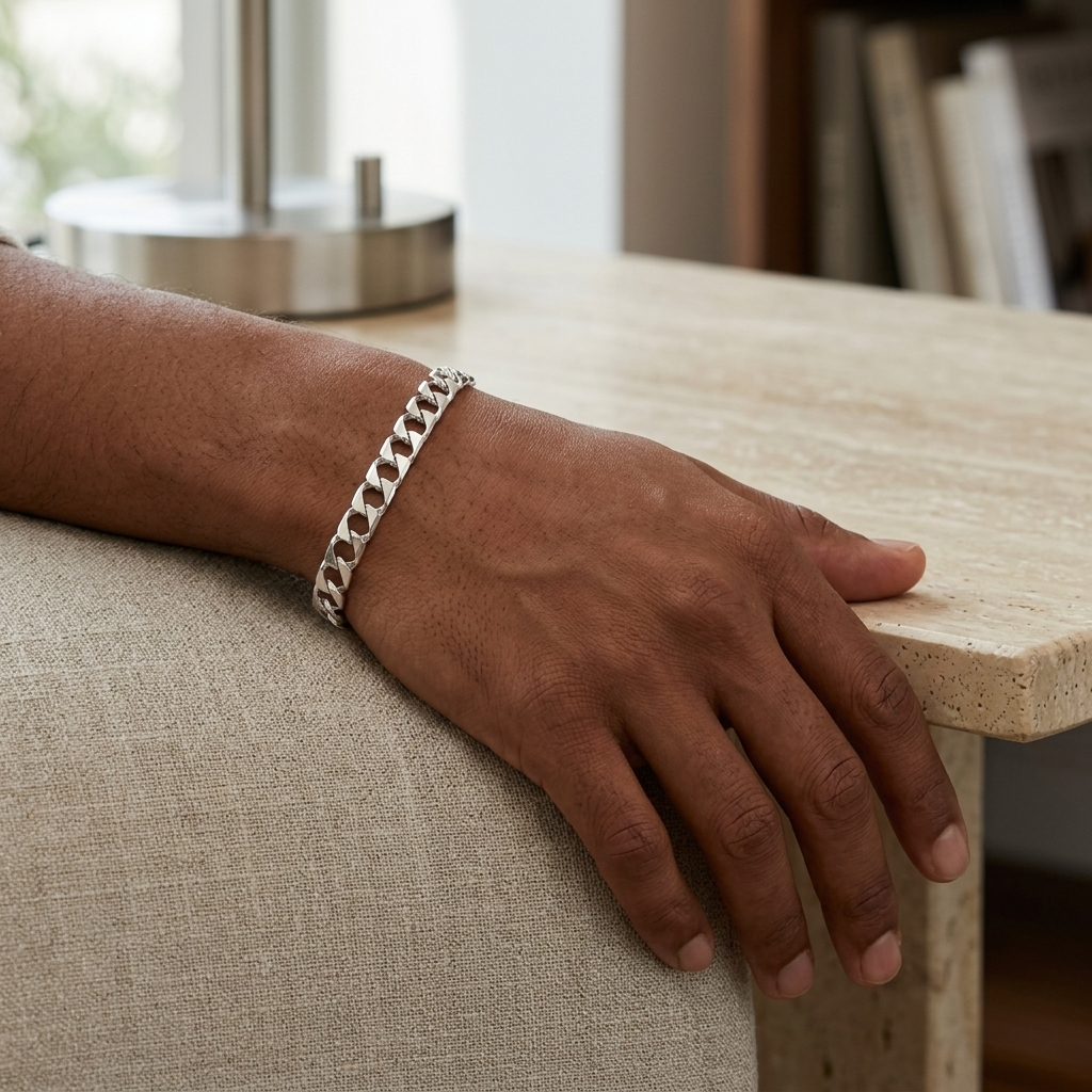 Full length of the wide curb chain bracelet showing its polished silver-tone finish