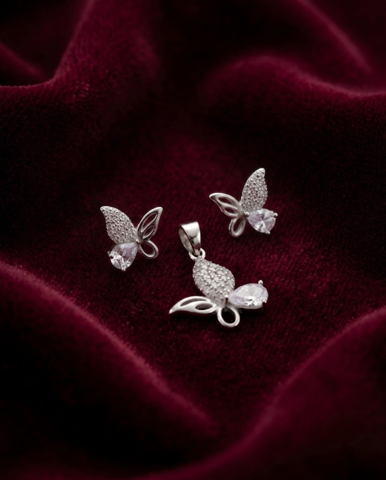 Silvme pure 925 sterling silver pink butterfly pendant and stud earrings set with pink cubic zirconia, side profile view