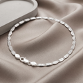 Full length of the flat mariner link bracelet showing its textured silver-tone finish
