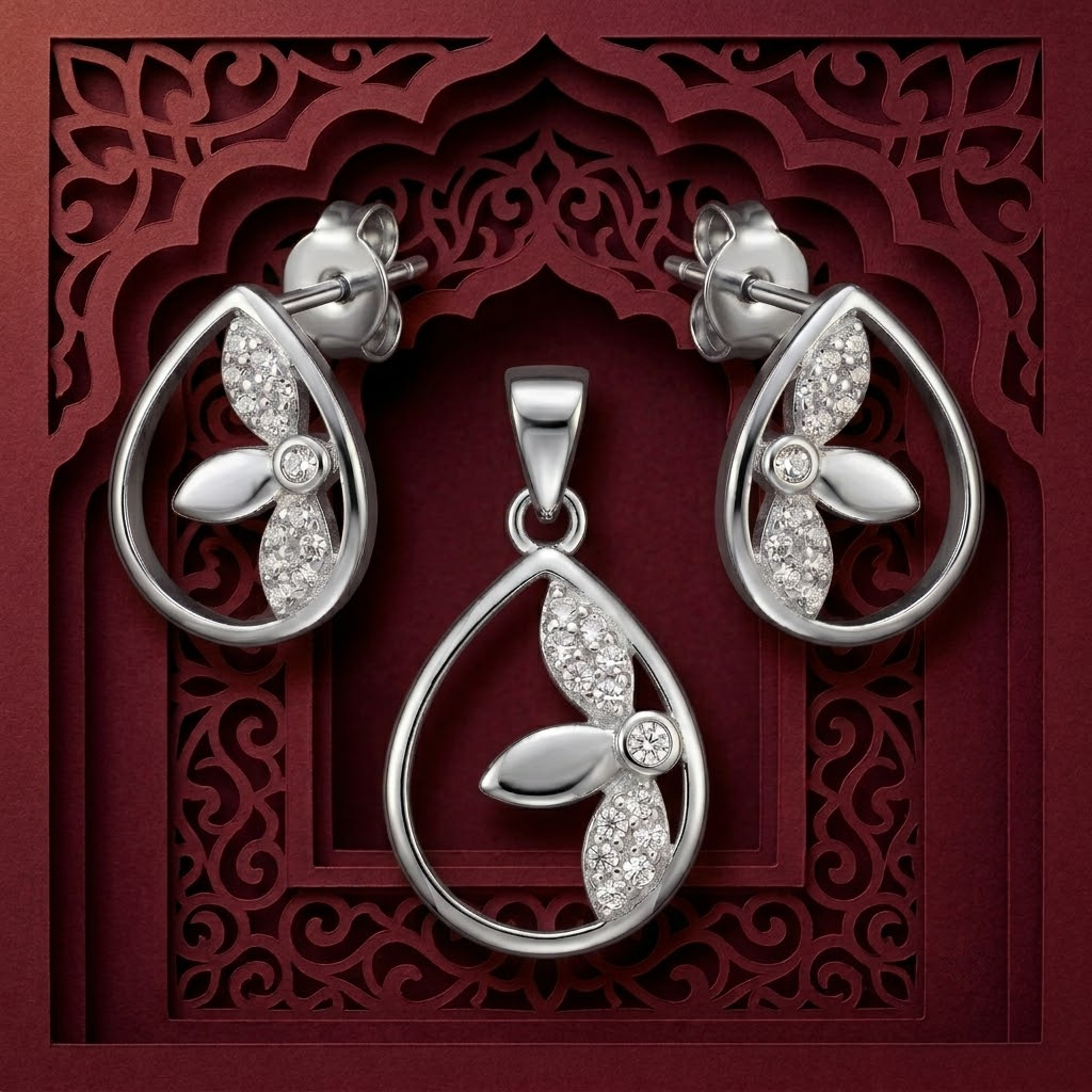 Teardrop 925 sterling silver pendant and drop earrings jewellery set with cubic zirconia by Silvme â€” angled studio view