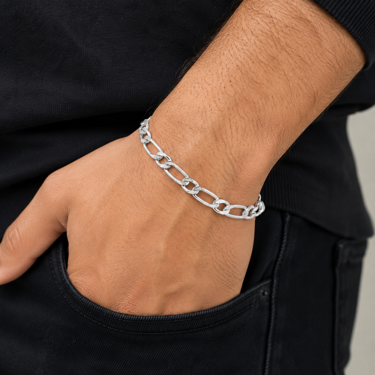 Full length of the faceted figaro chain bracelet showing its faceted silver-tone finish