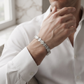 Close-up of round starburst medallions alternating with slim squared links on the Silvme floral medallion link bracelet