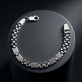 Full length of the panel link bracelet showing its polished silver-tone finish