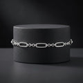 The oval and bead link bracelet for men shown against a plain studio background