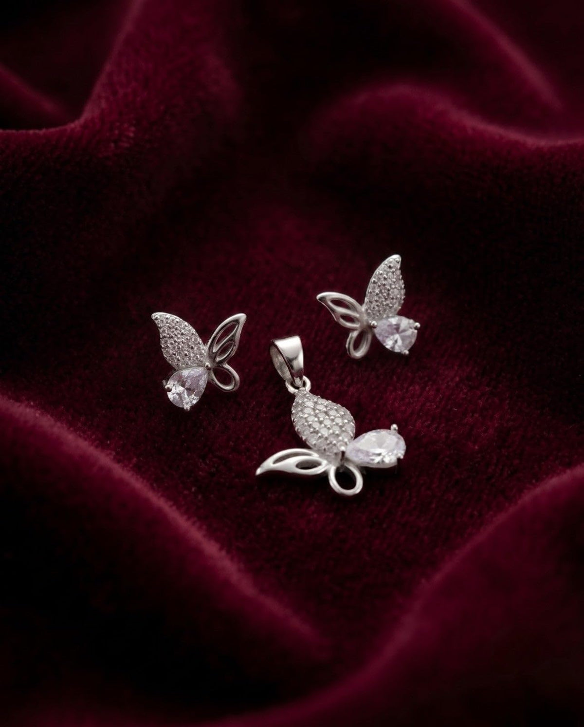 Silvme pure 925 sterling silver pink butterfly pendant and stud earrings set with pink cubic zirconia, side profile view