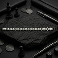 Full length of the floral medallion link bracelet showing its polished silver-tone finish