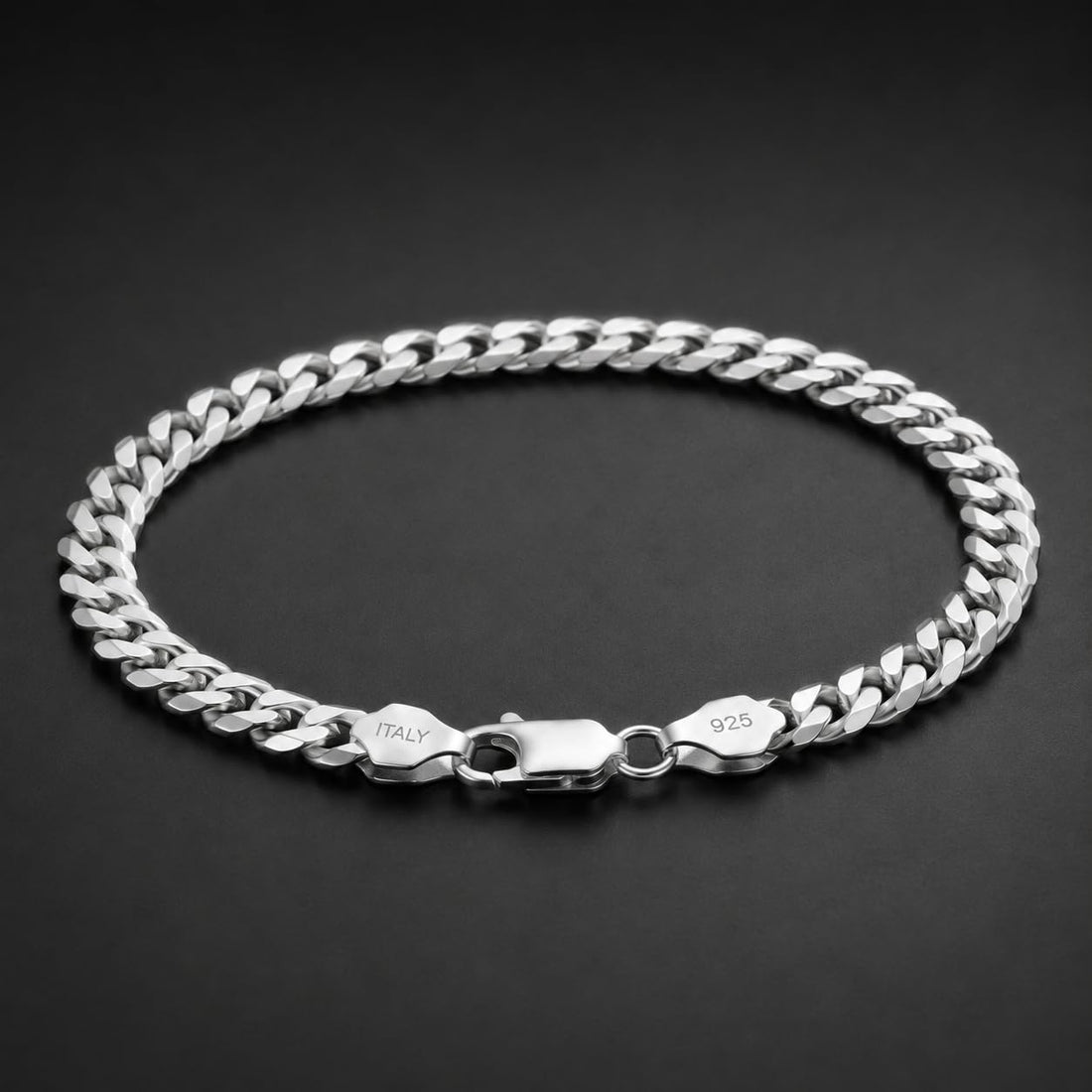 Full length of the heavy curb chain bracelet showing its polished silver-tone finish