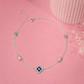 Charm, bead and chain detail on the Silvme clover evil eye & green stone 925 silver anklet payal