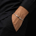 The rope chain id bracelet for men shown against a plain studio background
