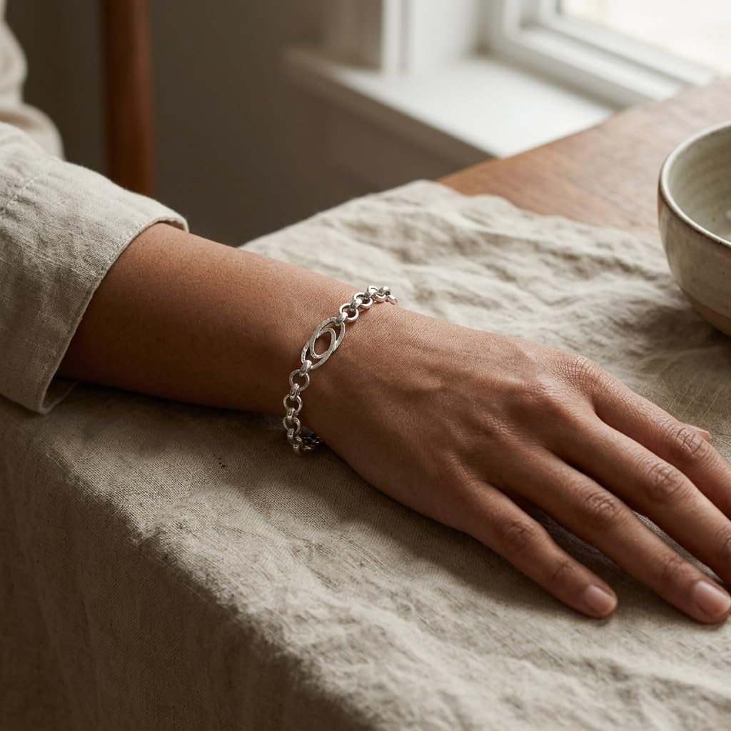 Full length of the oval station rolo bracelet showing its polished silver-tone finish