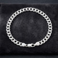The polished curb chain bracelet for men shown against a plain studio background