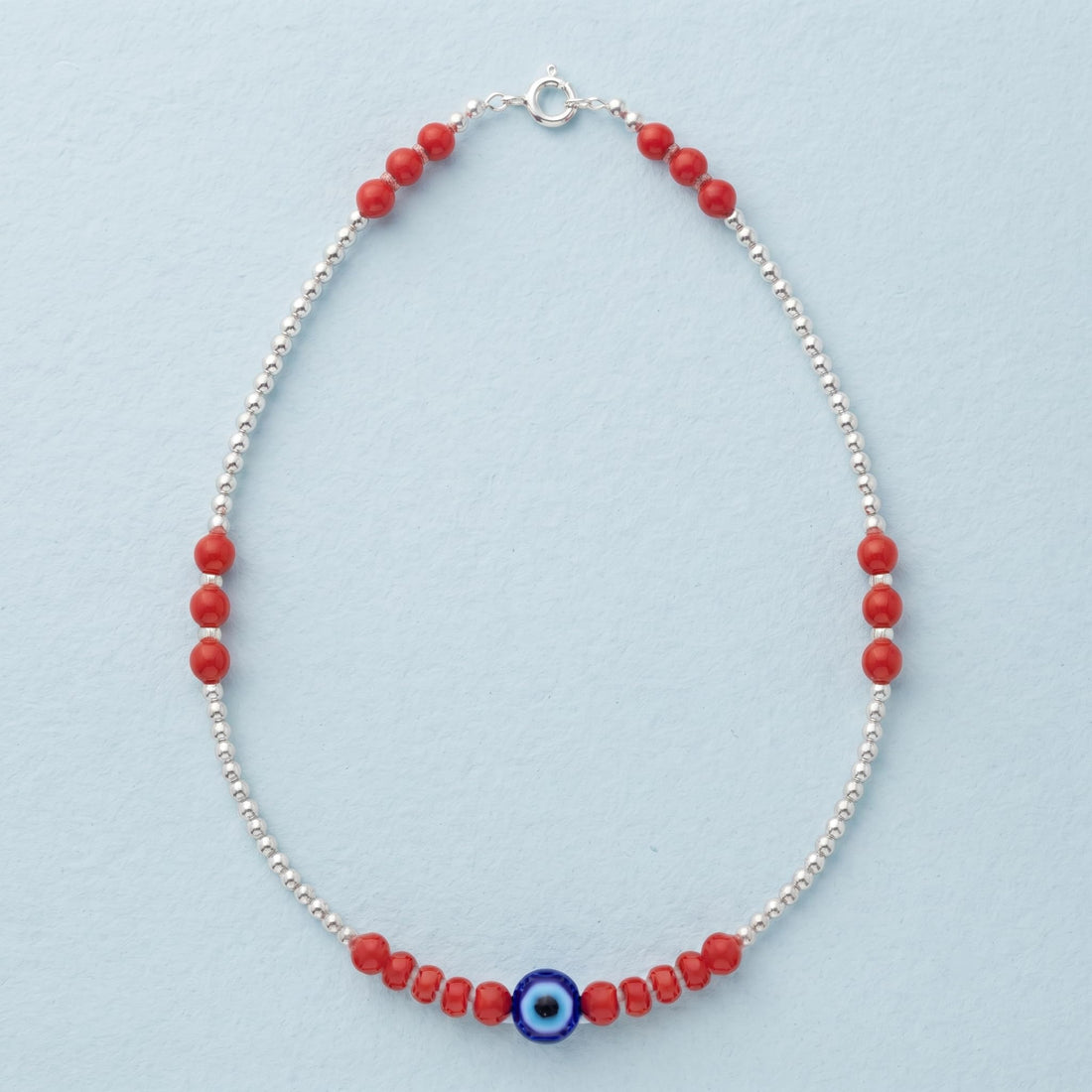 Silvme 925 sterling silver red bead evil eye anklet with red beads and a blue evil-eye charm, white background full view