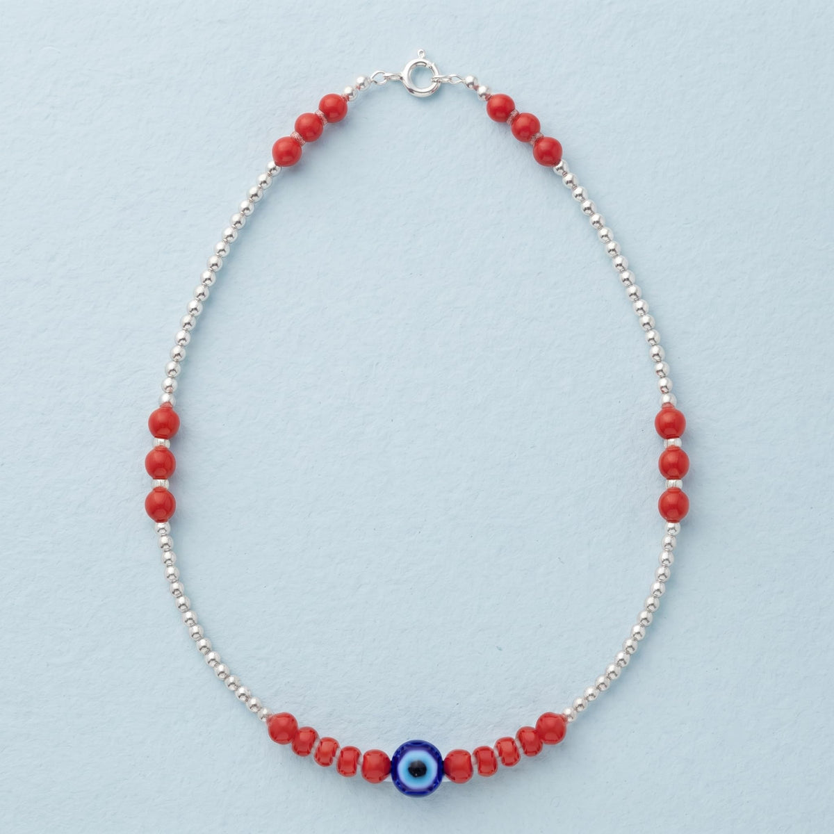 Silvme red bead evil eye 925 silver anklet with red beads and a blue evil-eye charm, full-length view