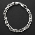Close-up of heavy interlocking links with a twisted, rope-like build on the Silvme chunky twisted link bracelet
