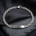 Close-up of a slim engraveable-style plate set into a fine twisted rope chain on the Silvme rope chain id bracelet