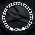 Close-up of a broad flat curb chain built for real presence on the wrist on the Silvme wide curb chain bracelet