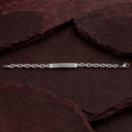 Full length of the rope chain id bracelet showing its polished silver-tone finish