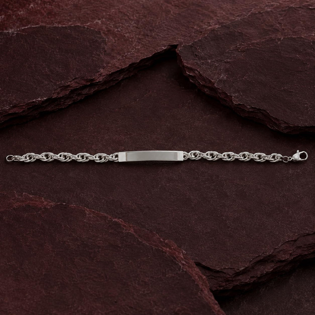 Full length of the rope chain id bracelet showing its polished silver-tone finish