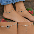 Close-up of twin lashed evil-eye charms and oval beads on the Silvme 925 sterling silver evil eye charm anklet