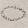 Full length of the textured rolo chain bracelet showing its polished silver-tone finish