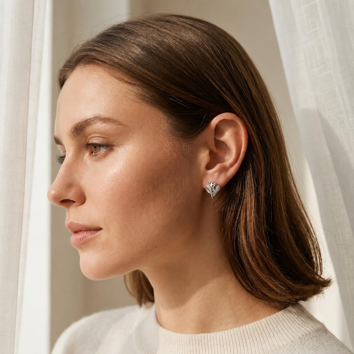 Black Swirl Leaf 925 silver stud earrings for women, everyday wear, styled on fabric