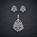 Silvme pure 925 sterling silver sparkling cubic zirconia pendant and stud earrings set with cubic zirconia, styled flatlay view