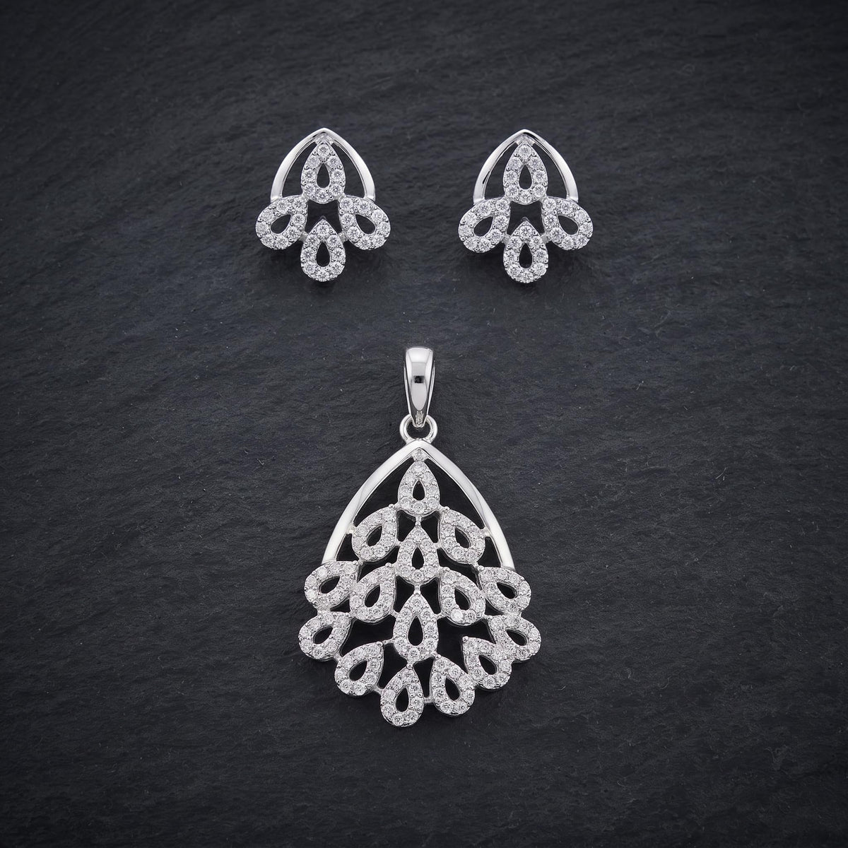 Silvme pure 925 sterling silver sparkling cubic zirconia pendant and stud earrings set with cubic zirconia, styled flatlay view
